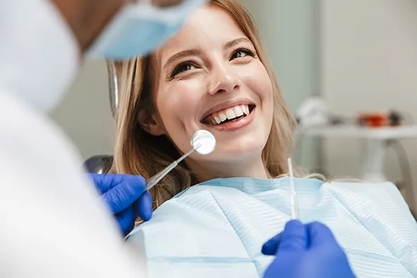 White female patient happily waiting in a dental chair for her dentist to begin her routine dental exam at Rolling Plains Dentistry in Quanah, TX